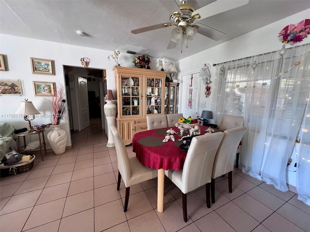 tiled dining space with visible vents and a ceiling fan