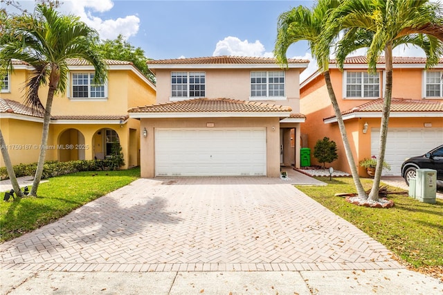 view of front of house featuring decorative driveway, a front yard, and stucco siding