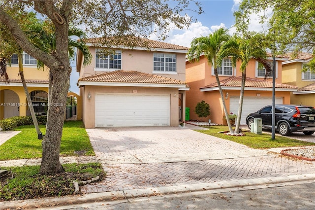 view of front of home with a front yard, decorative driveway, and stucco siding