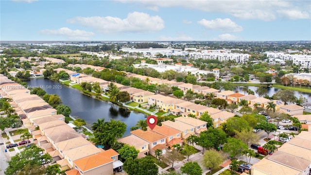 drone / aerial view with a residential view and a water view