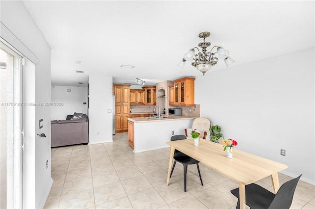 dining room featuring an inviting chandelier and light tile patterned floors