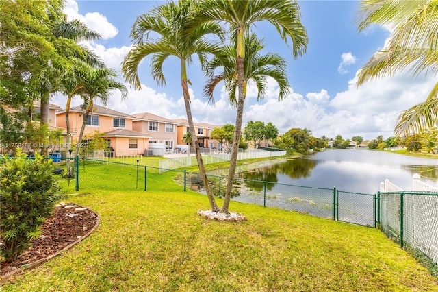 view of yard featuring a residential view, a gate, a water view, and fence