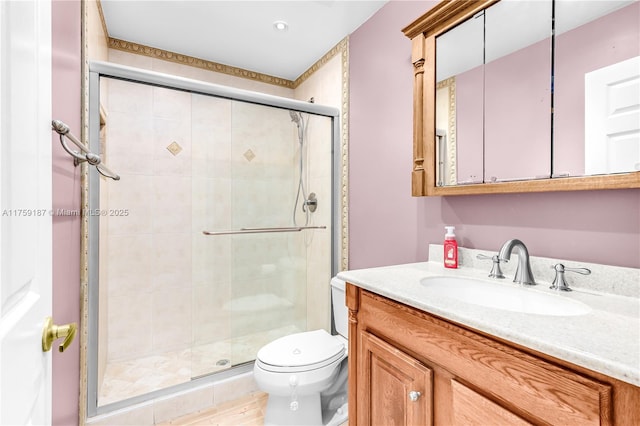 full bath with a shower stall, toilet, and vanity