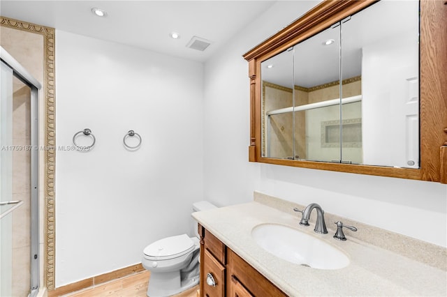 bathroom featuring toilet, recessed lighting, visible vents, vanity, and a stall shower