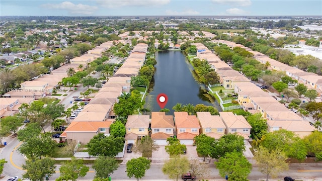 birds eye view of property with a water view and a residential view