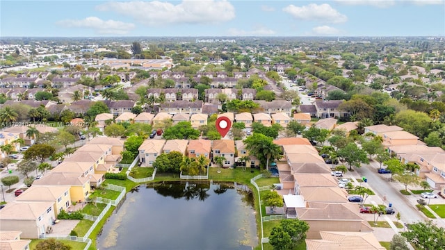 birds eye view of property with a water view and a residential view