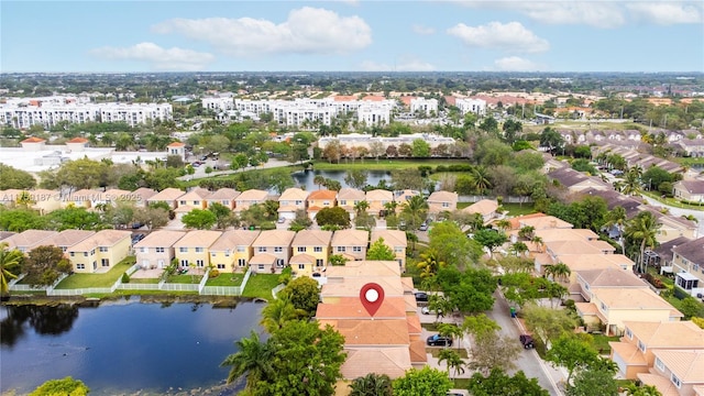 drone / aerial view featuring a residential view and a water view