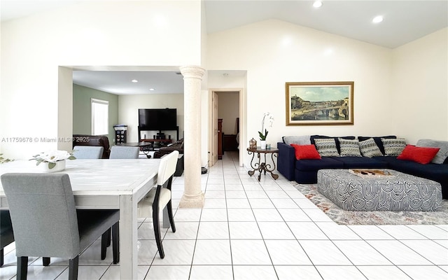 dining space featuring light tile patterned floors, recessed lighting, high vaulted ceiling, and decorative columns