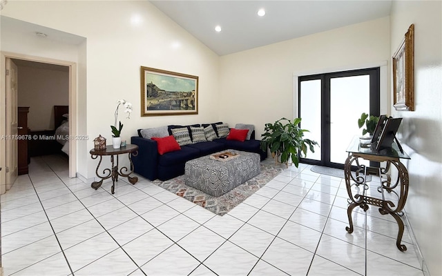 living room with light tile patterned floors, french doors, baseboards, and high vaulted ceiling