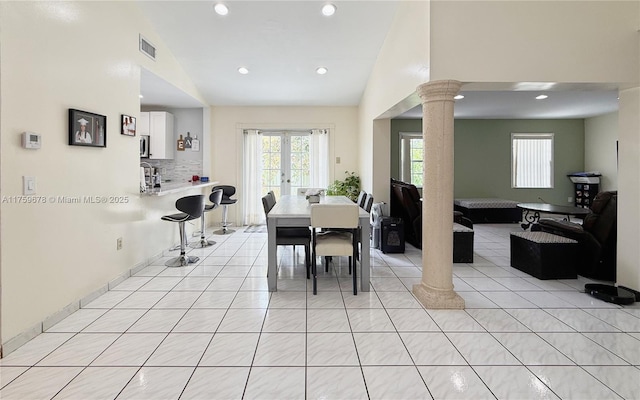 dining room with light tile patterned floors, visible vents, ornate columns, and plenty of natural light