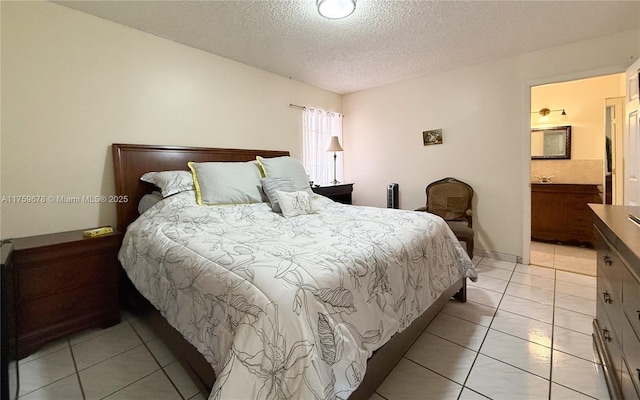 bedroom featuring light tile patterned floors and a textured ceiling