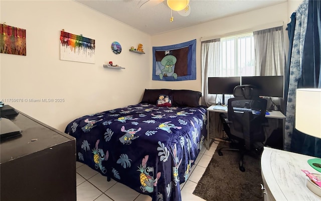 tiled bedroom with a ceiling fan