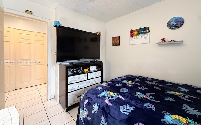 bedroom with light tile patterned floors and a textured ceiling