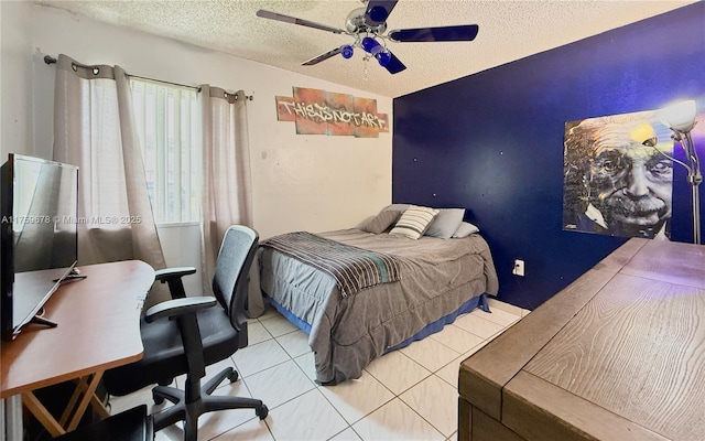 tiled bedroom featuring ceiling fan and a textured ceiling