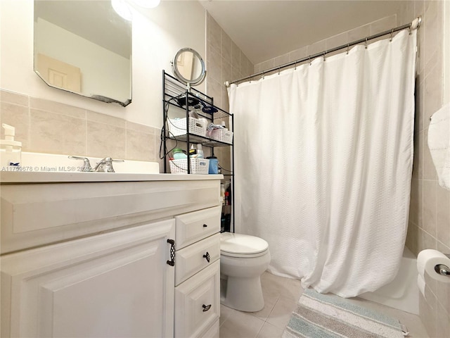 full bath featuring tile patterned floors, toilet, tile walls, and vanity