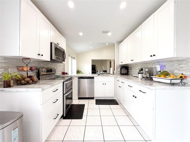 kitchen with stainless steel appliances, visible vents, light tile patterned flooring, and white cabinetry