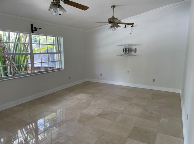 spare room featuring ornamental molding, a ceiling fan, and baseboards