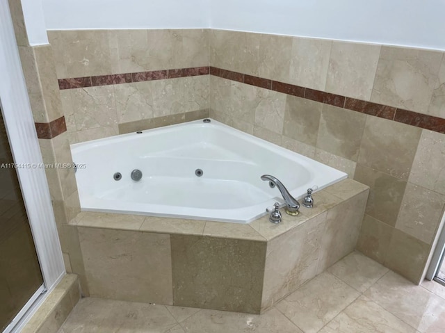 full bathroom with a whirlpool tub