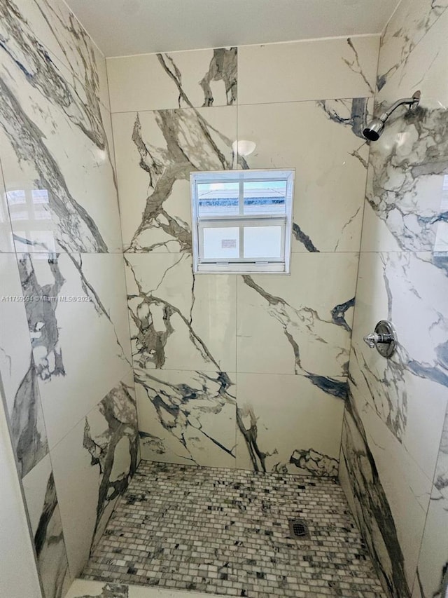 full bath featuring a marble finish shower