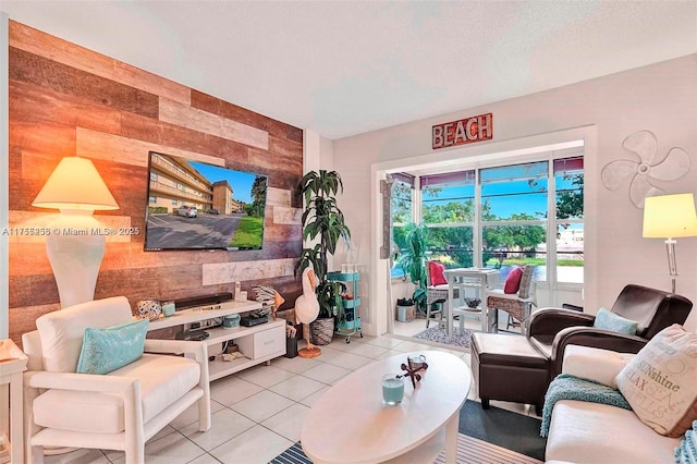 living room featuring light tile patterned flooring and a textured ceiling