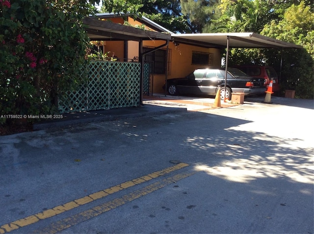 view of vehicle parking with an attached carport