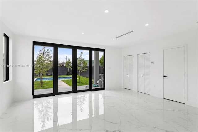 spare room with marble finish floor and recessed lighting