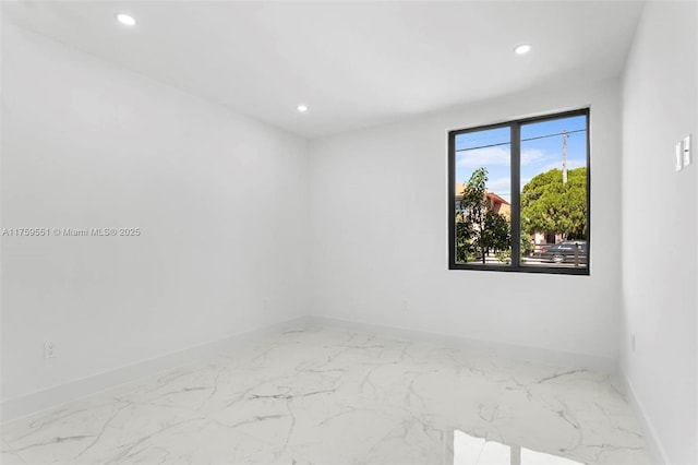 unfurnished room with baseboards and recessed lighting