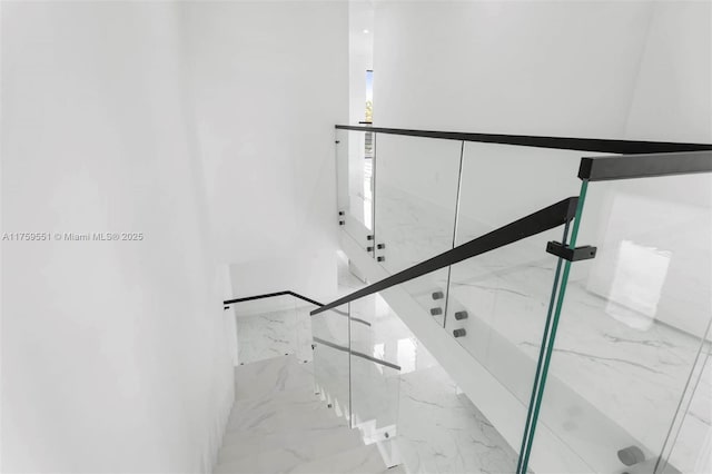 stairs featuring marble finish floor