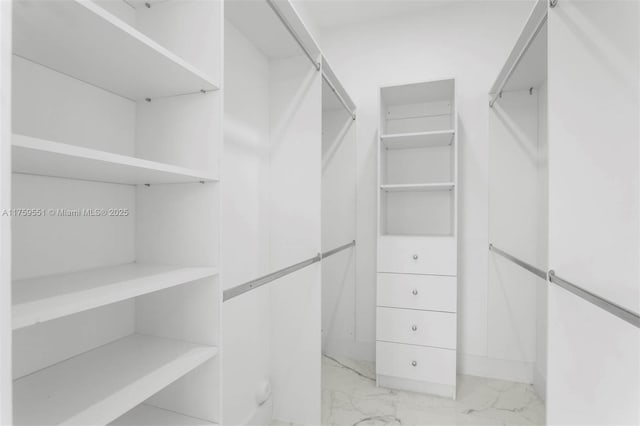 spacious closet with marble finish floor