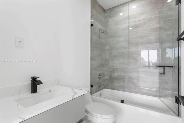 full bathroom featuring washtub / shower combination, vanity, and toilet