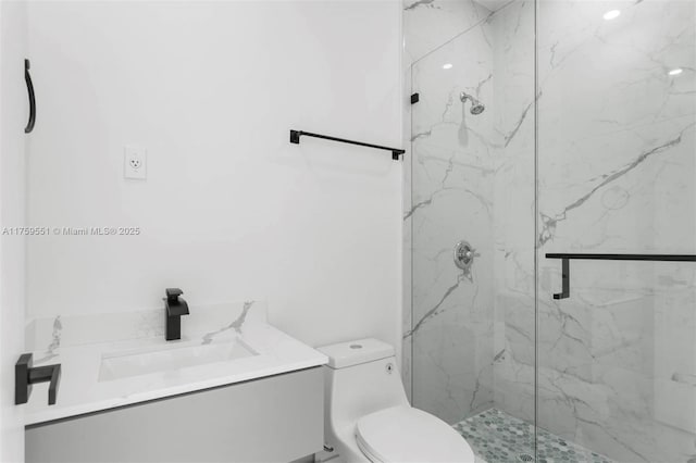 full bathroom with vanity, a marble finish shower, and toilet