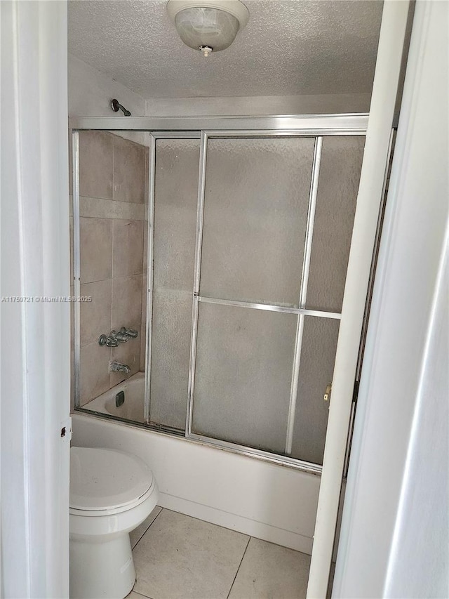 6670 Royal Palm Unit K 202, Pompano Beach, FL 33063 - full bath featuring tile patterned floors, toilet, shower / bath combination with glass door, and a textured ceiling
