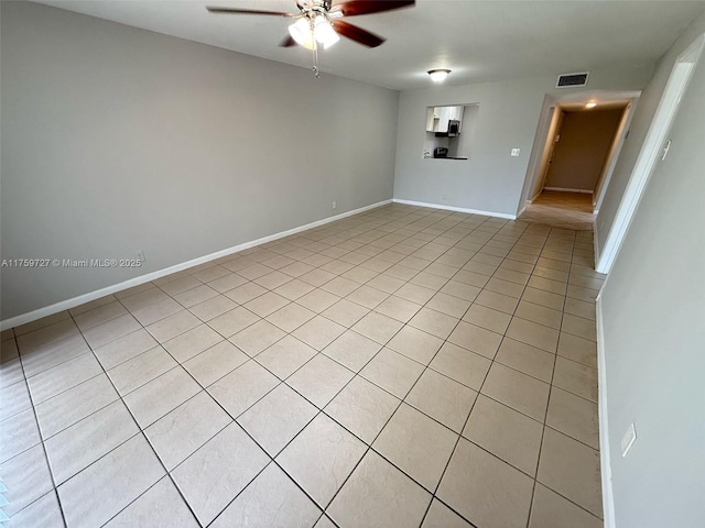 unfurnished room featuring baseboards, visible vents, and a ceiling fan