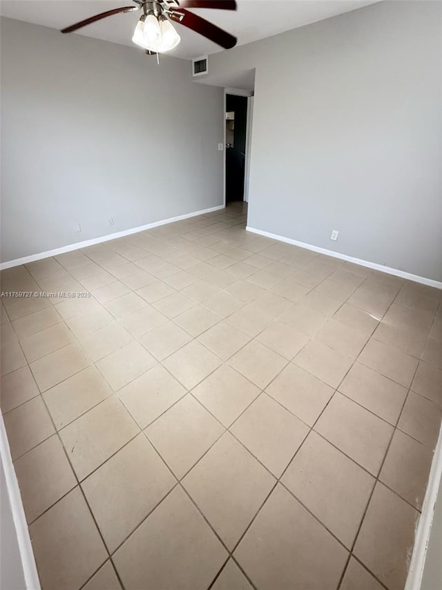 unfurnished room with light tile patterned floors, ceiling fan, visible vents, and baseboards