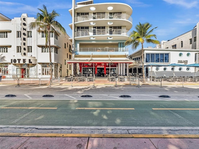 view of property featuring uncovered parking and fence