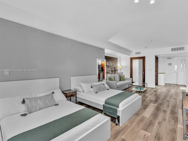 bedroom featuring visible vents and light wood finished floors