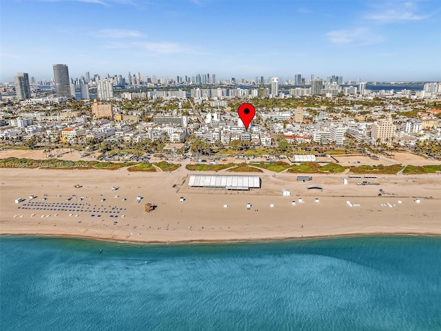 aerial view with a beach view, a water view, and a city view