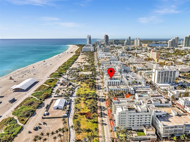 birds eye view of property featuring a view of the beach, a view of city, and a water view