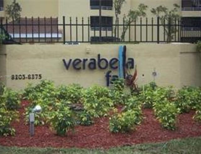 community / neighborhood sign with fence