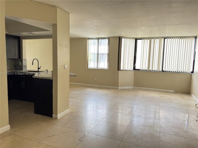 interior space with baseboards and a sink