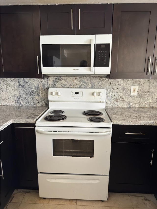 kitchen with marble finish floor, dark brown cabinets, light countertops, white range with electric stovetop, and backsplash