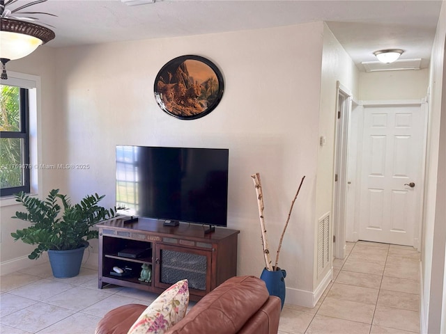 living area featuring visible vents, baseboards, and light tile patterned floors