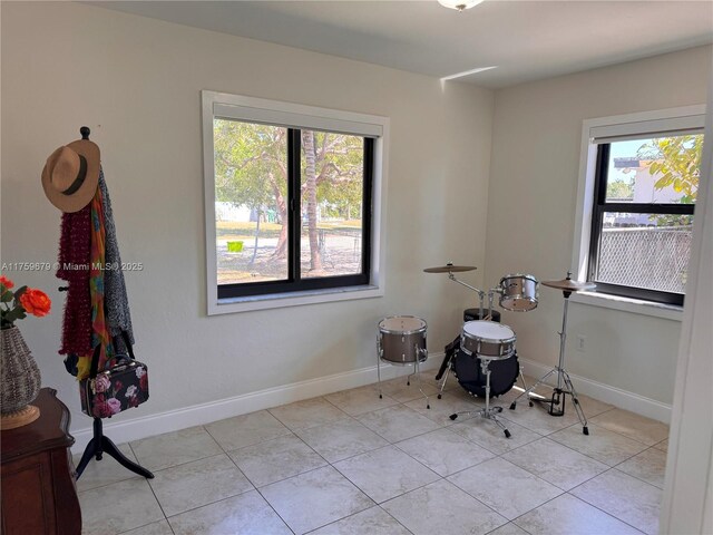 misc room featuring plenty of natural light and baseboards