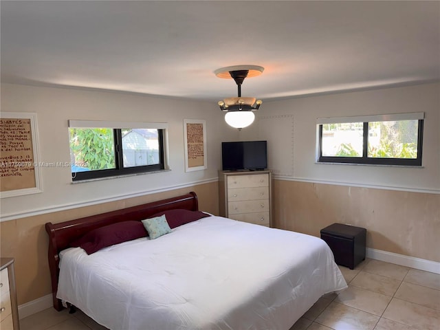 bedroom featuring baseboards and light tile patterned floors