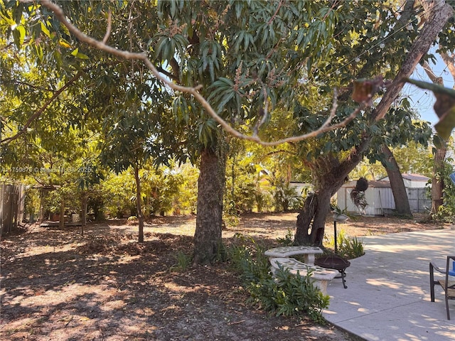 view of yard featuring fence and a patio