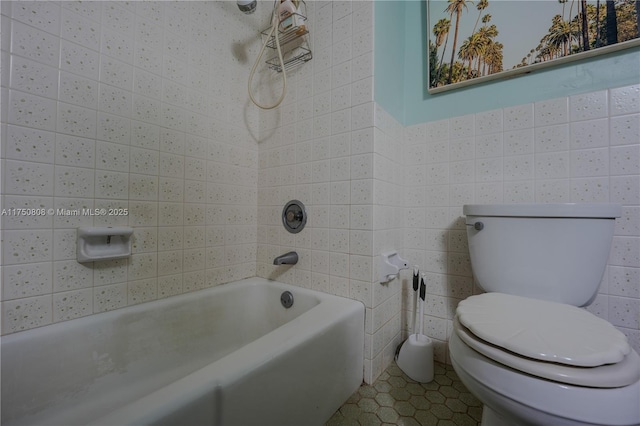 bathroom with tile patterned flooring, tile walls, and toilet