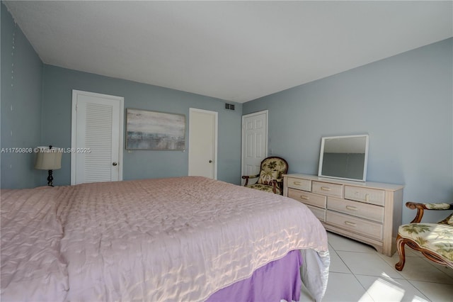 bedroom with light tile patterned floors and visible vents