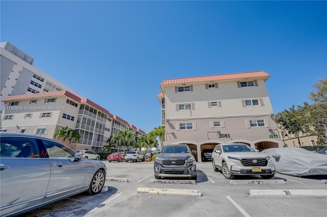 view of building exterior featuring uncovered parking