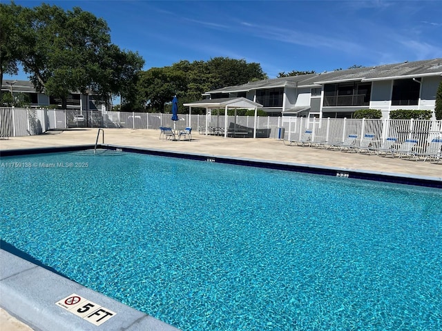 pool featuring a patio and fence