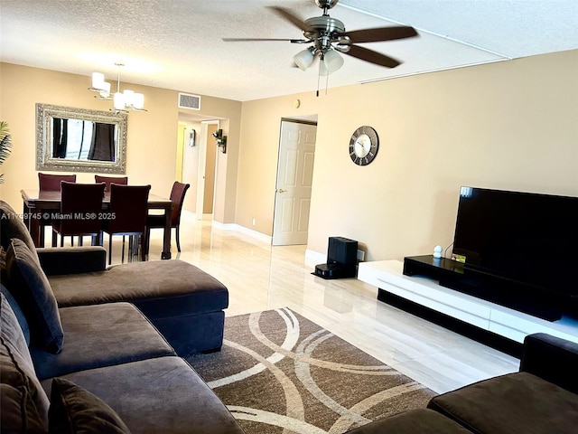 living room with baseboards, visible vents, marble finish floor, a textured ceiling, and ceiling fan with notable chandelier